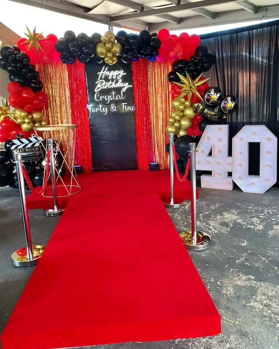 Hollywood-inspired 40th birthday: red carpet, marquee lights, glam balloons, and bold decor.