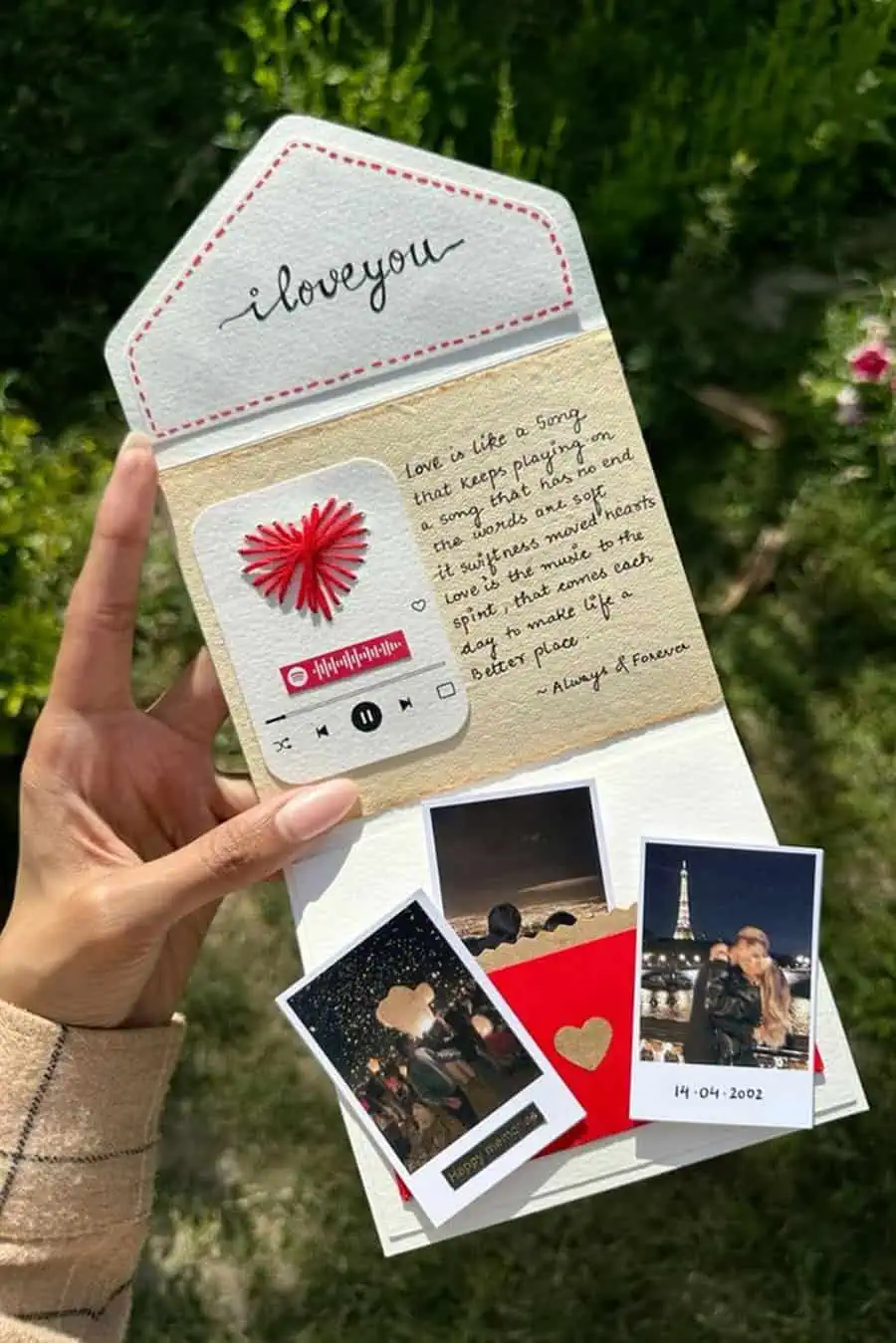 Handmade anniversary card with photos, a love message, and a Spotify-themed heart design.