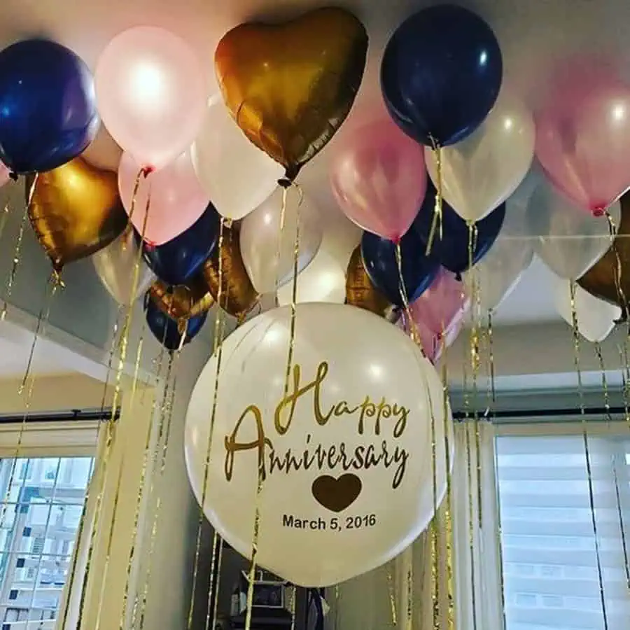 A dreamy anniversary balloon decoration with personalized messages and elegant colors.