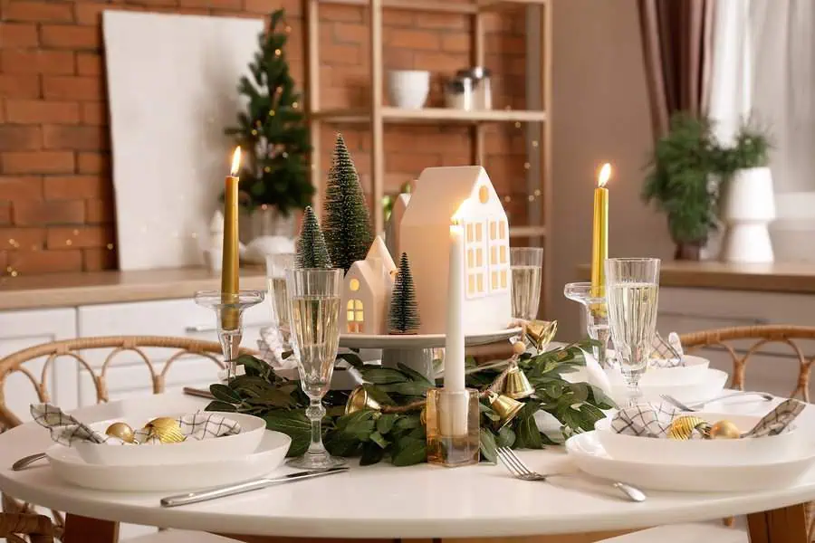 Crystal candleholders with candles and holiday-themed decor for a festive dining table ambiance.