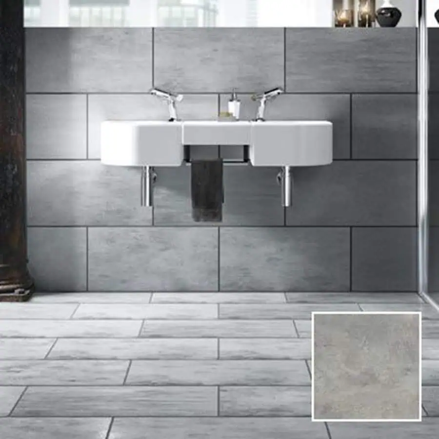 Modern bathroom with grey floor and wall tiles, dark grout, and a sleek white double sink.