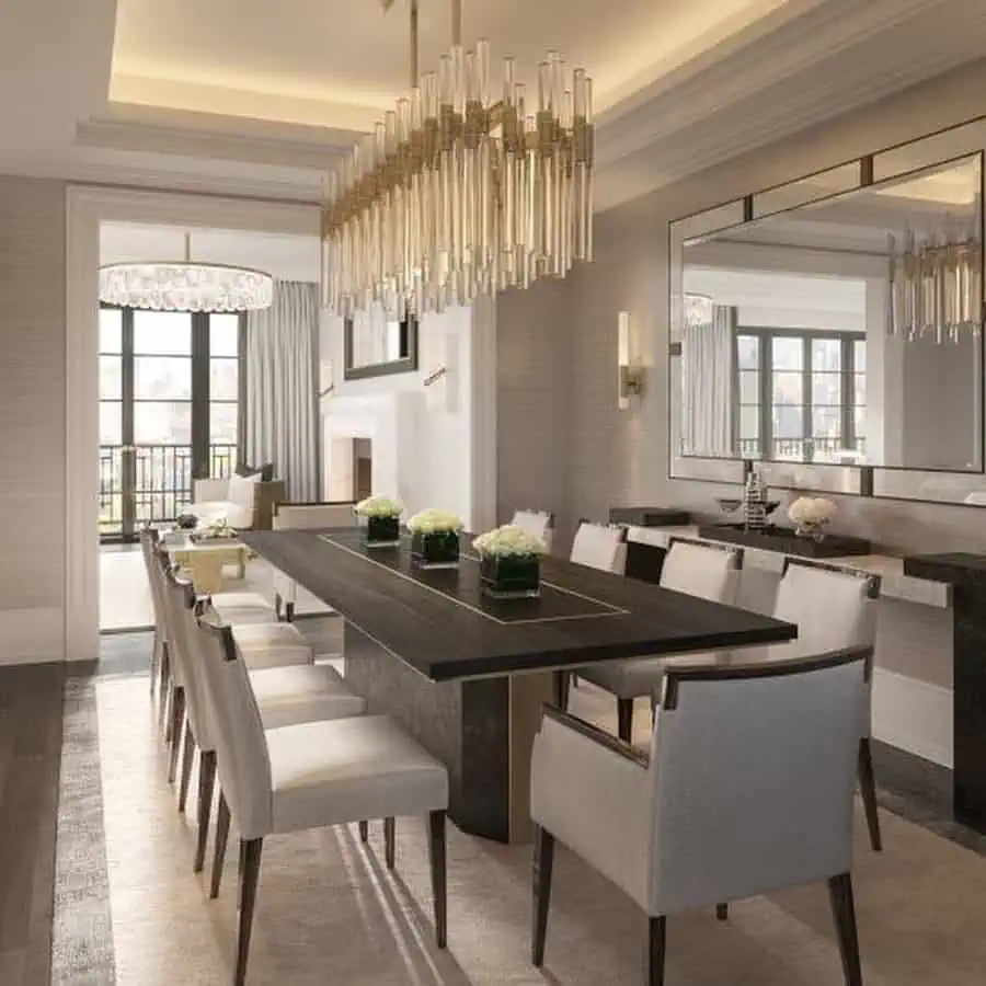 Elegant dining table decor with a dark wood table, cream chairs, floral arrangements, and chandeliers.