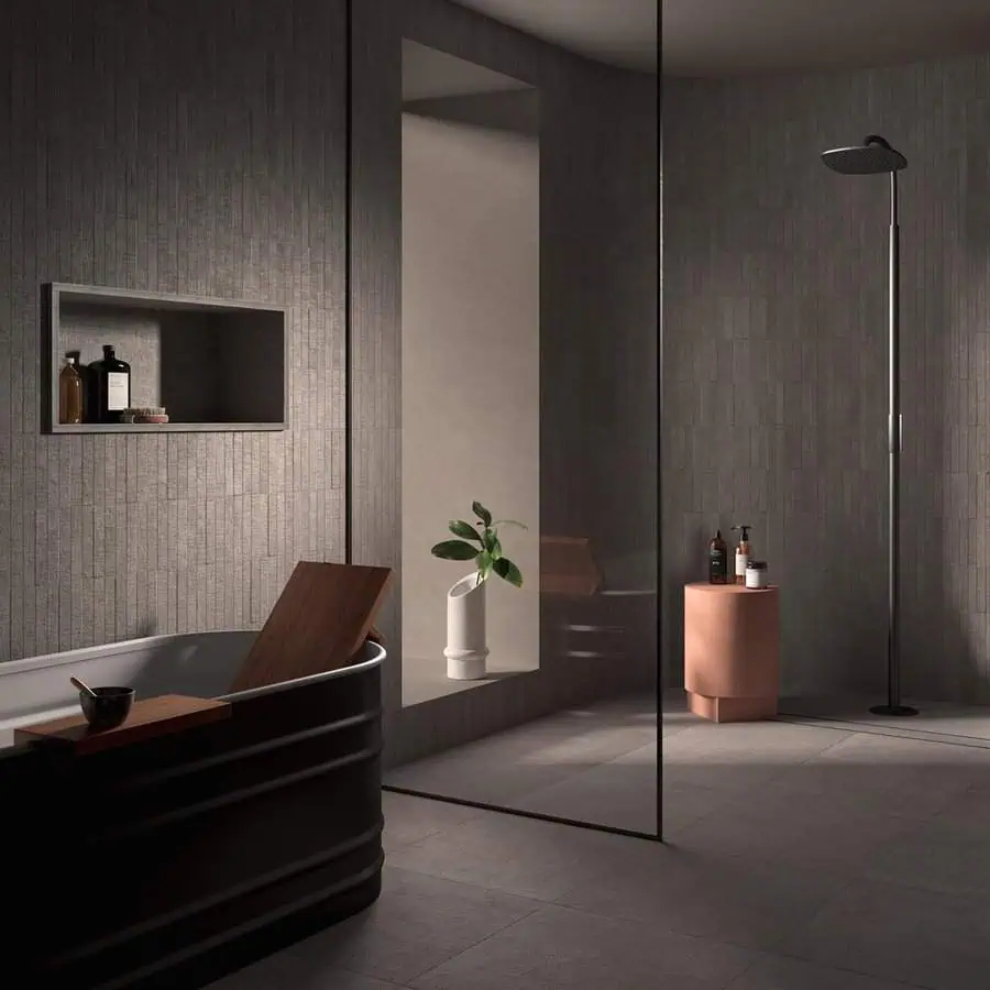 Elegant bathroom with grey floor and wall tiles, black tub, and modern walk-in shower.