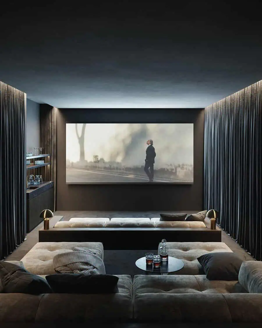 Modern home theater with tiered seating, plush cushions, and an ambient lighting setup.