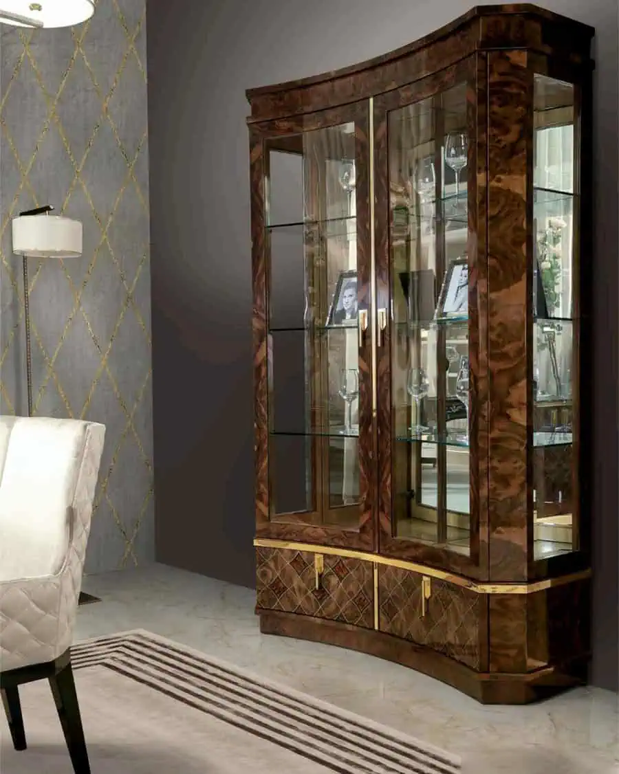 Elegant living room corner with a dark wood glass display cabinet and a patterned wall.