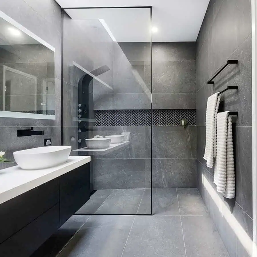 Open-concept bathroom with sleek grey tiles and modern black accents for a contemporary touch.