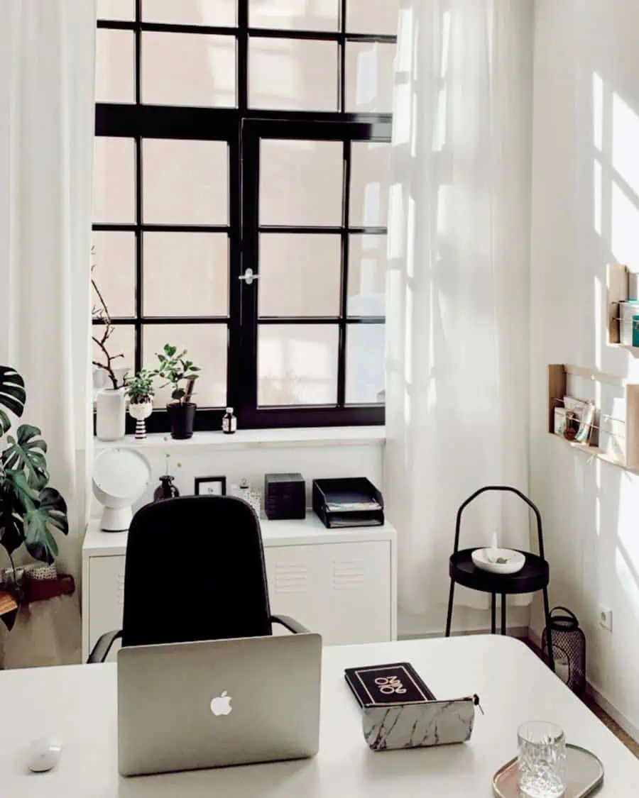 Scandinavian home office with large windows, minimal decor, and natural light.