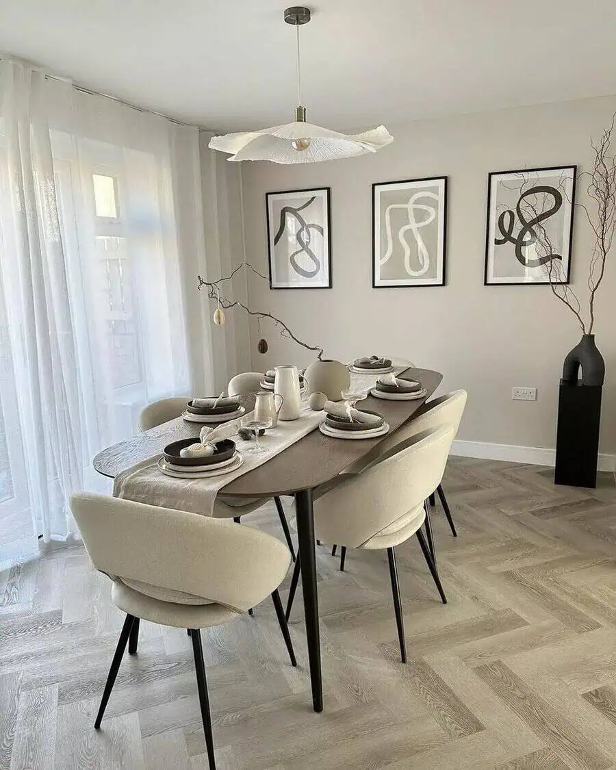 Scandinavian dining room with modern decor, abstract wall art, and minimalist table setting.