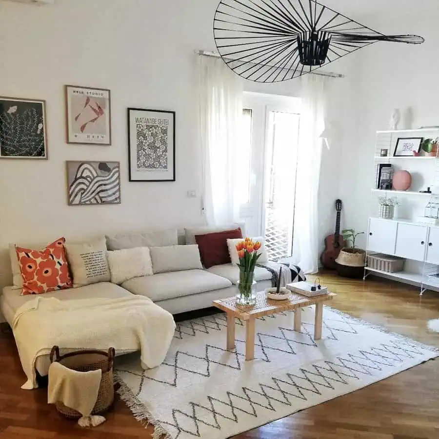 Scandinavian living room with cozy decor, patterned cushions, and modern wall art.