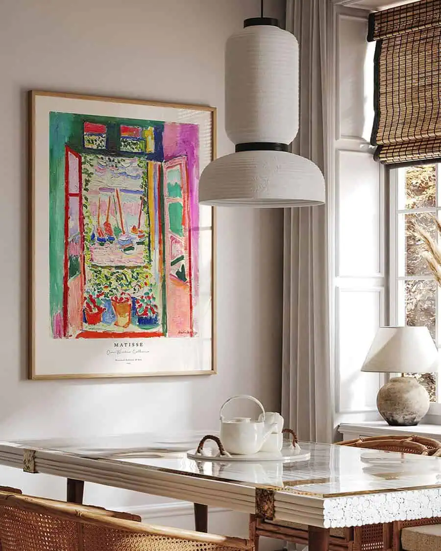 Scandinavian dining area with vibrant Matisse artwork and natural decor accents.