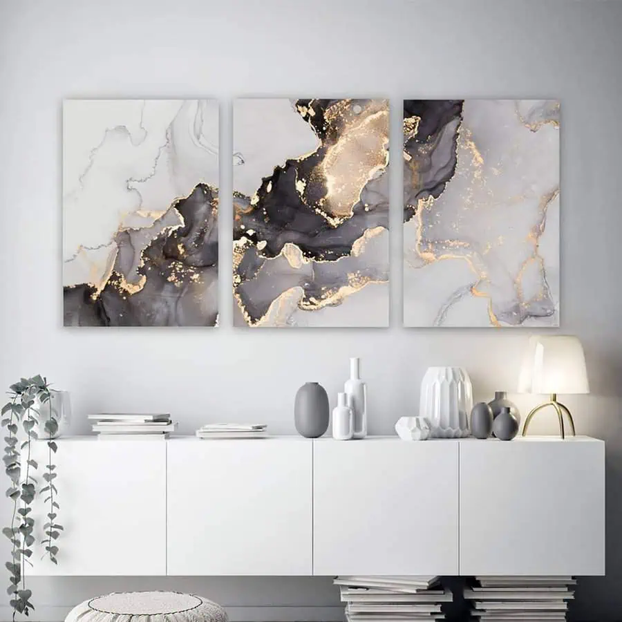 Modern Scandinavian aesthetic with abstract gold-accented wall art, minimalist decor, and sleek white furniture.