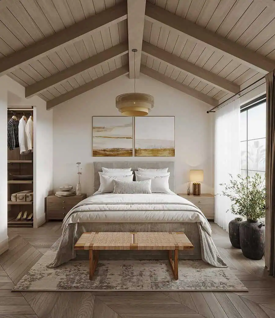 Spanish-style bedroom with vaulted wooden ceiling, neutral bedding, and minimalist decor.