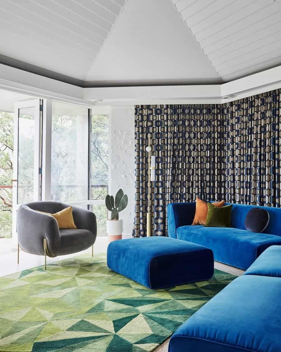 1960s glamorous living room with bold blue seating, geometric patterns, and retro-inspired decor.