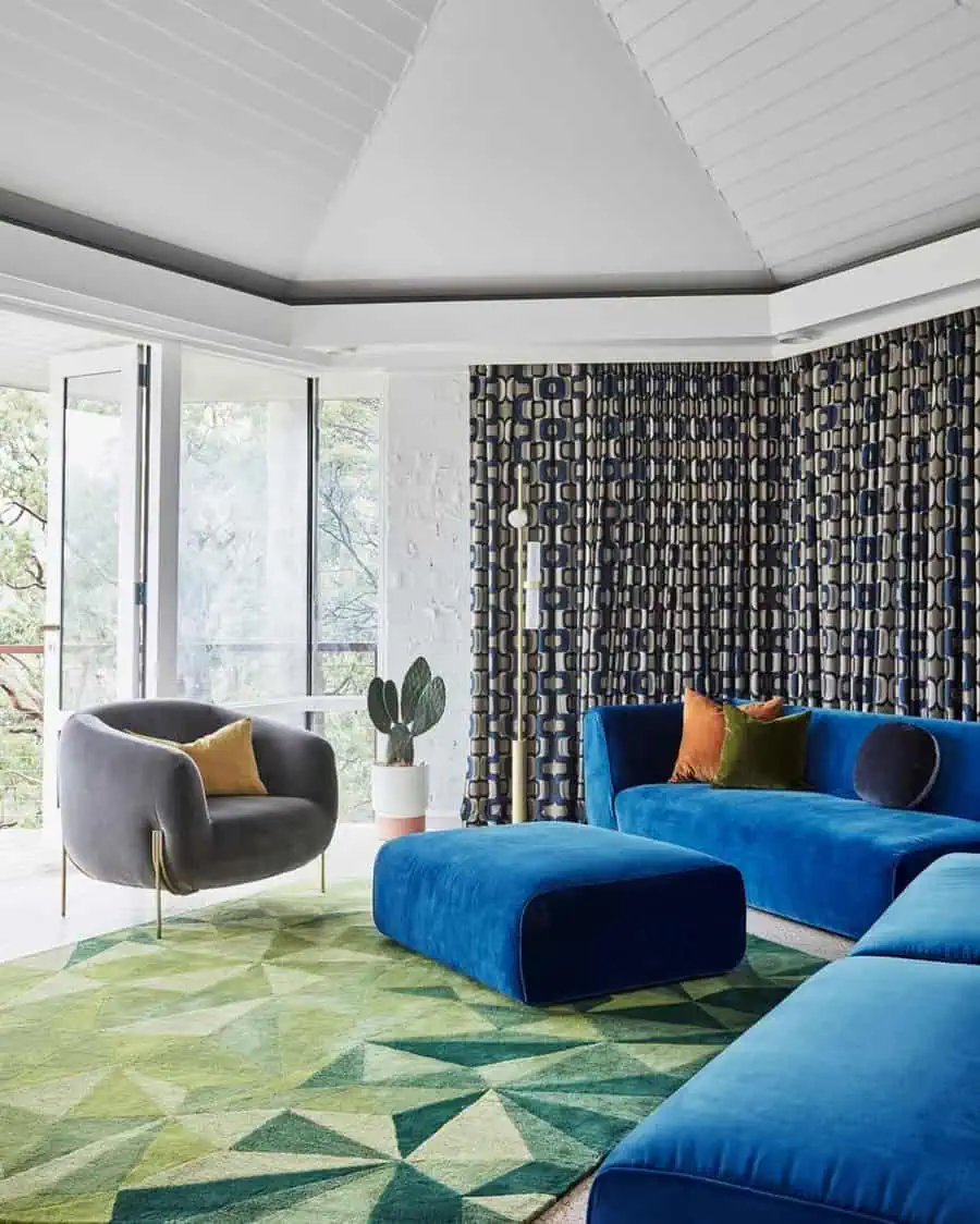 1960s glamorous living room with bold blue seating, geometric patterns, and retro-inspired decor.