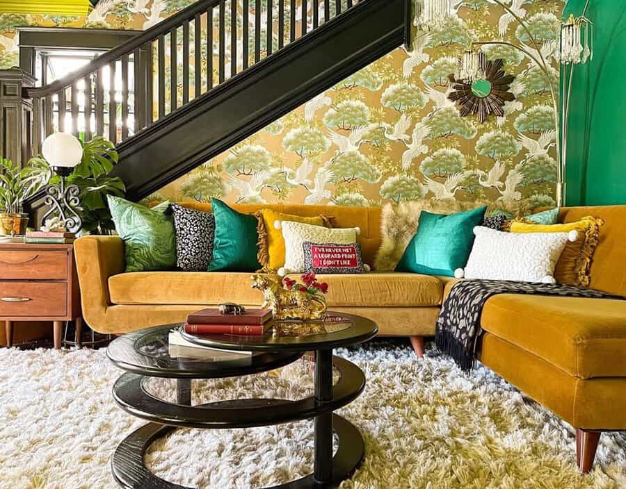 1960s-inspired living room with bold wallpaper, a mustard velvet sofa, and retro decor accents.