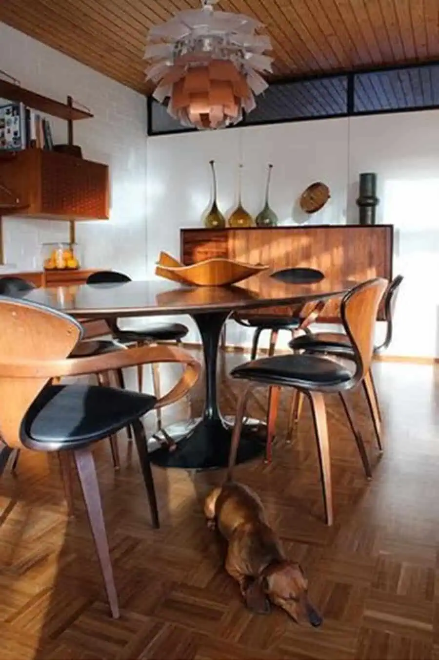 1960s Scandinavian dining room with mid-century modern furniture, wood accents, and retro lighting.