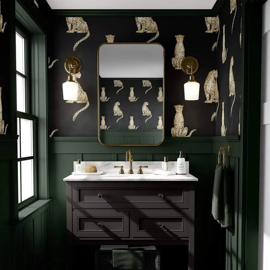 Chic black bathroom with bold cheetah-print wallpaper, green wainscoting, and gold accents.