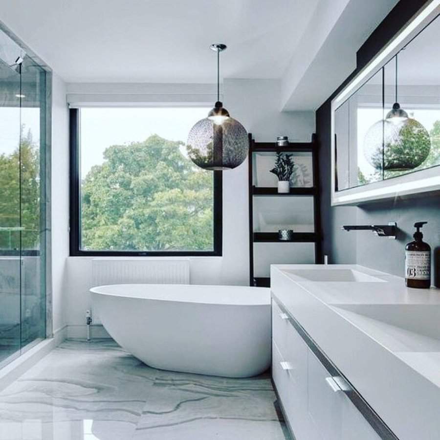 Black and white bathroom with a freestanding tub, black shelving, and large window views.