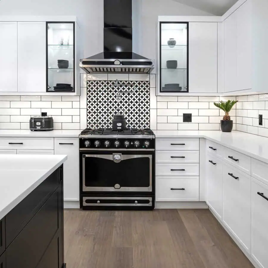 Bold geometric backsplash tiles add a striking focal point to contemporary cabinets for a modern, stylish kitchen.