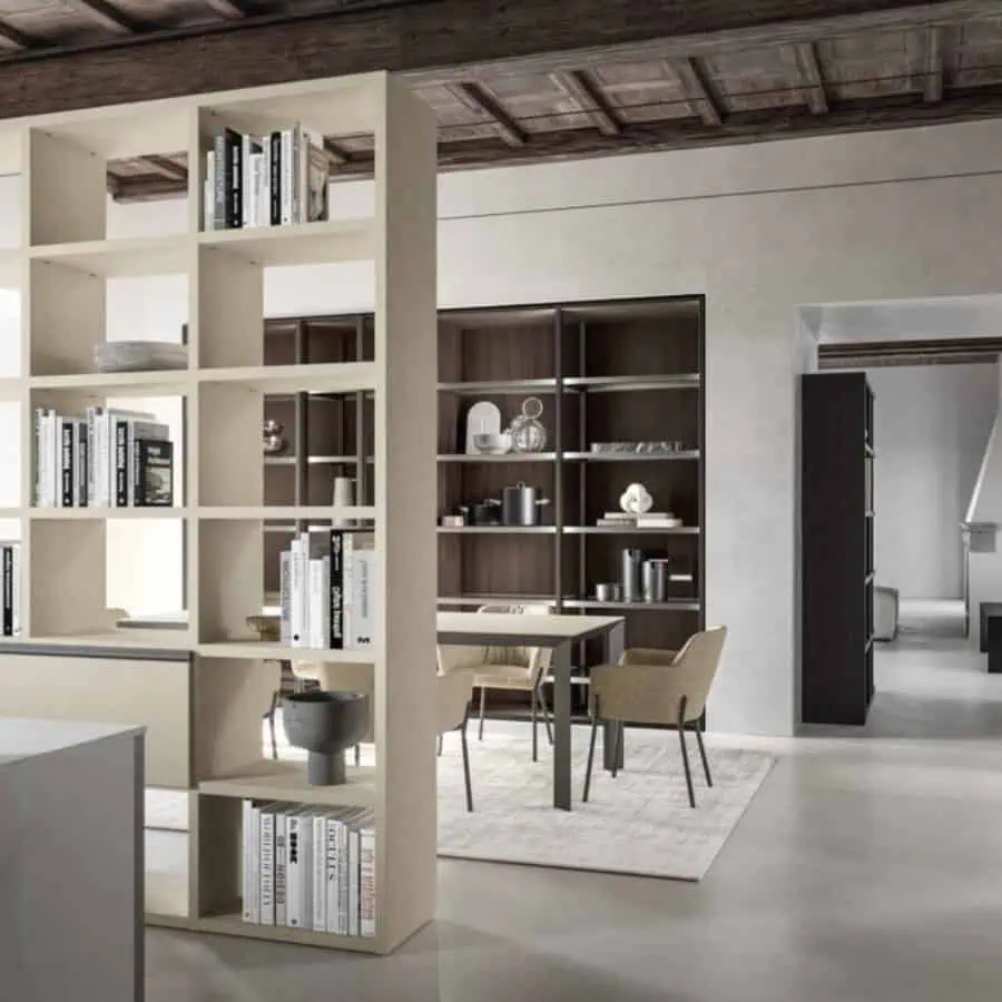 Bookshelf wall used as a stylish room divider with open shelving and decorative accents.