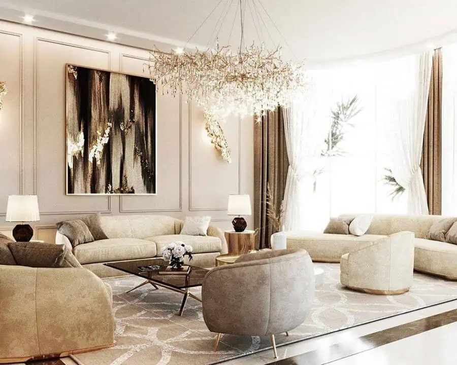 Luxurious carpeted living room with plush sofas, a crystal chandelier, and elegant decor.