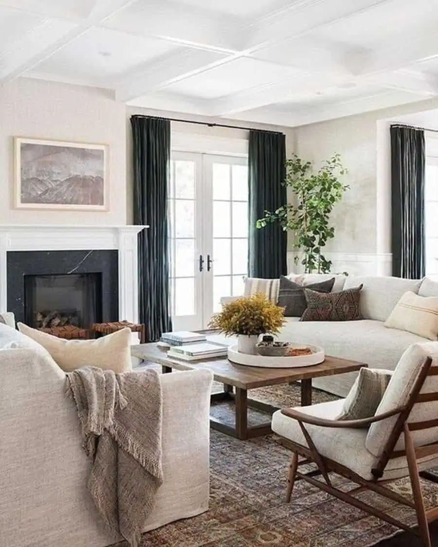 Cozy carpeted living room with a neutral sofa, wooden accents, and a fireplace centerpiece.