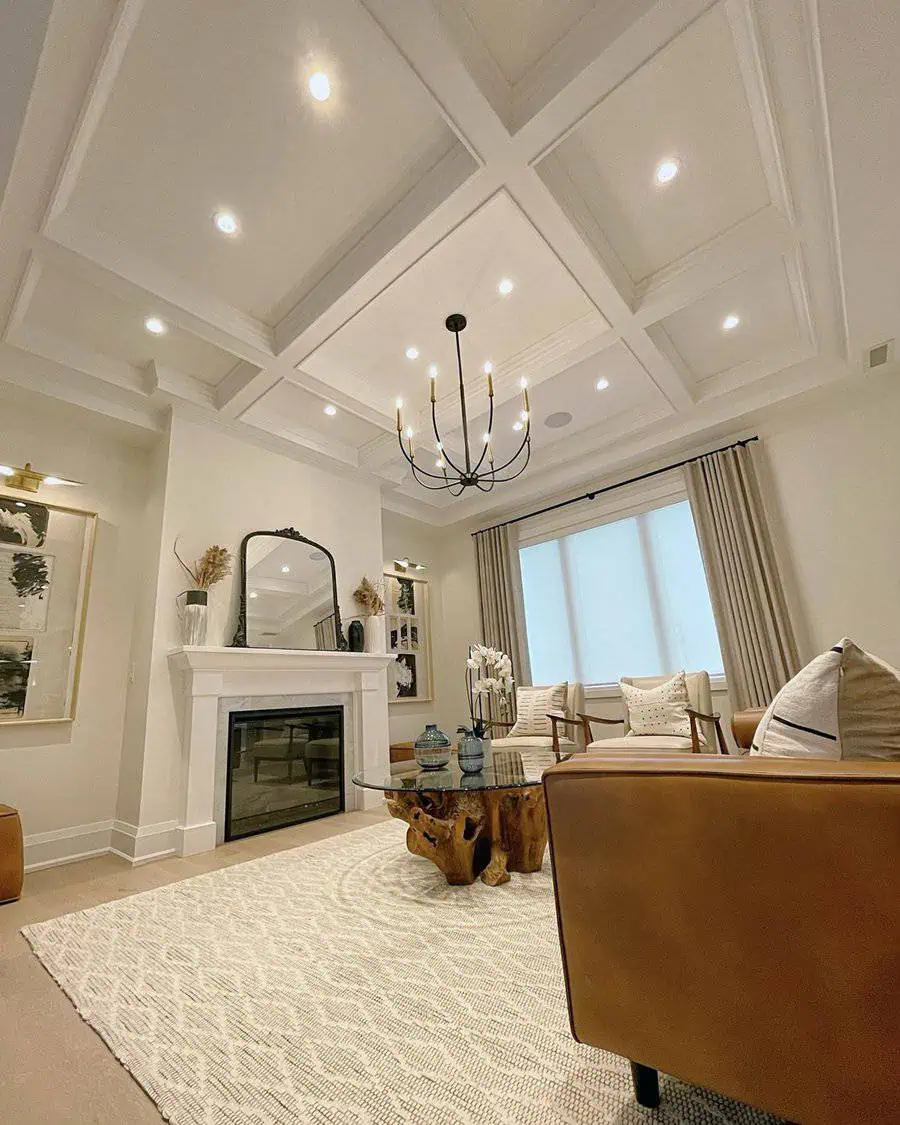 Contemporary living room with a coffered ceiling, fireplace, leather seating, and a rustic coffee table.