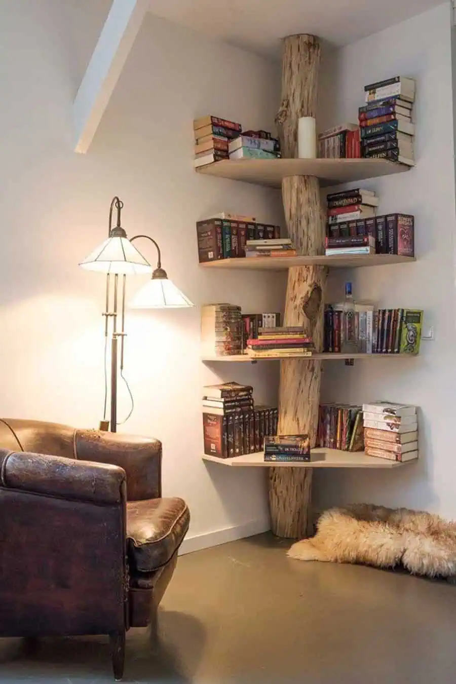 Rustic living room with a tree trunk bookshelf, cozy lighting, and a vintage leather armchair.