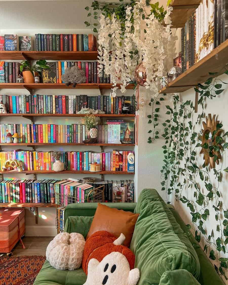 Cozy corner home library with colorful bookshelves, a plush green couch, and hanging plants.