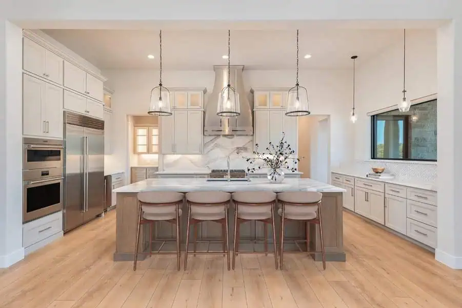 Dining room blending painted and natural finishes, featuring mixed wood tones, elegant lighting, and a warm, inviting ambiance.