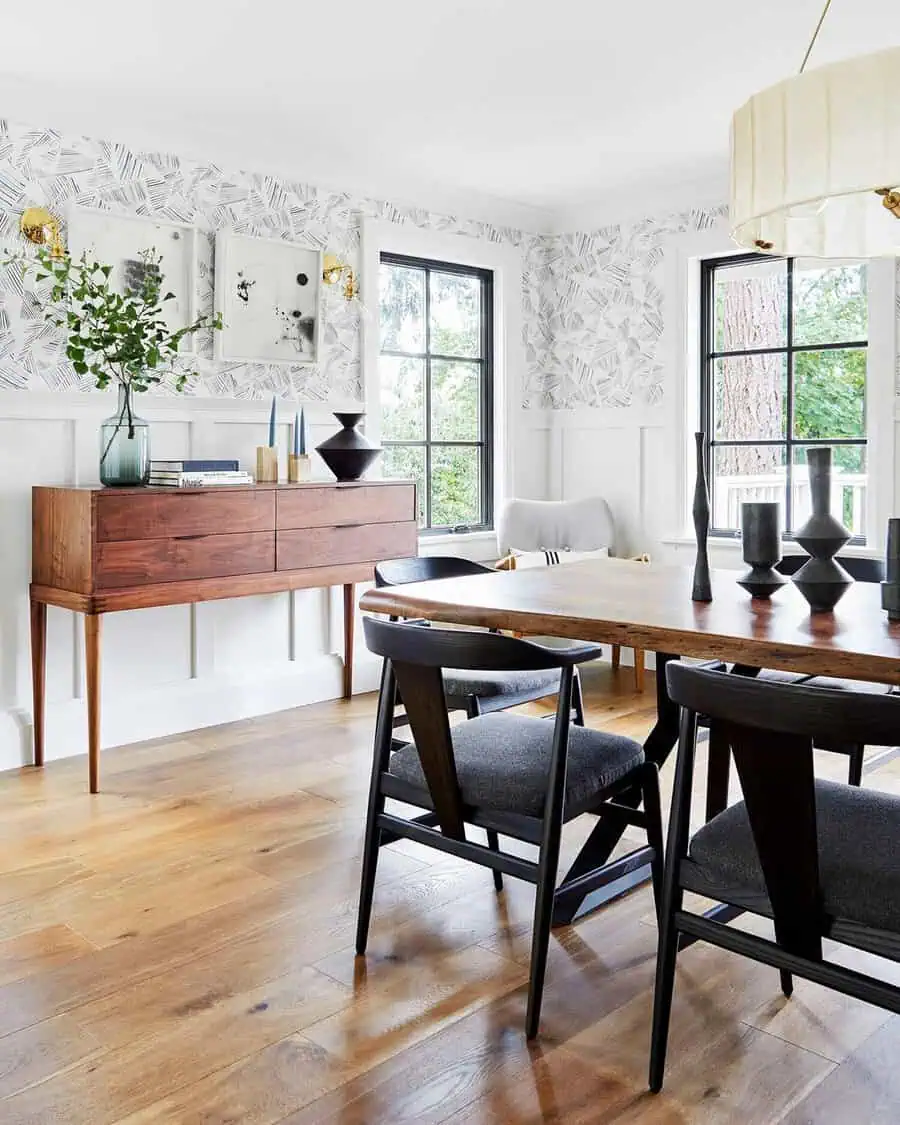 Dining room showcasing perfect contrast with unique wood stains, black chairs, and modern decor.