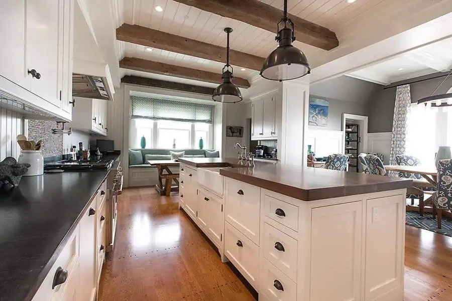 Dutch Colonial Revival interior with exposed wooden beams, a spacious kitchen island, and classic farmhouse details.