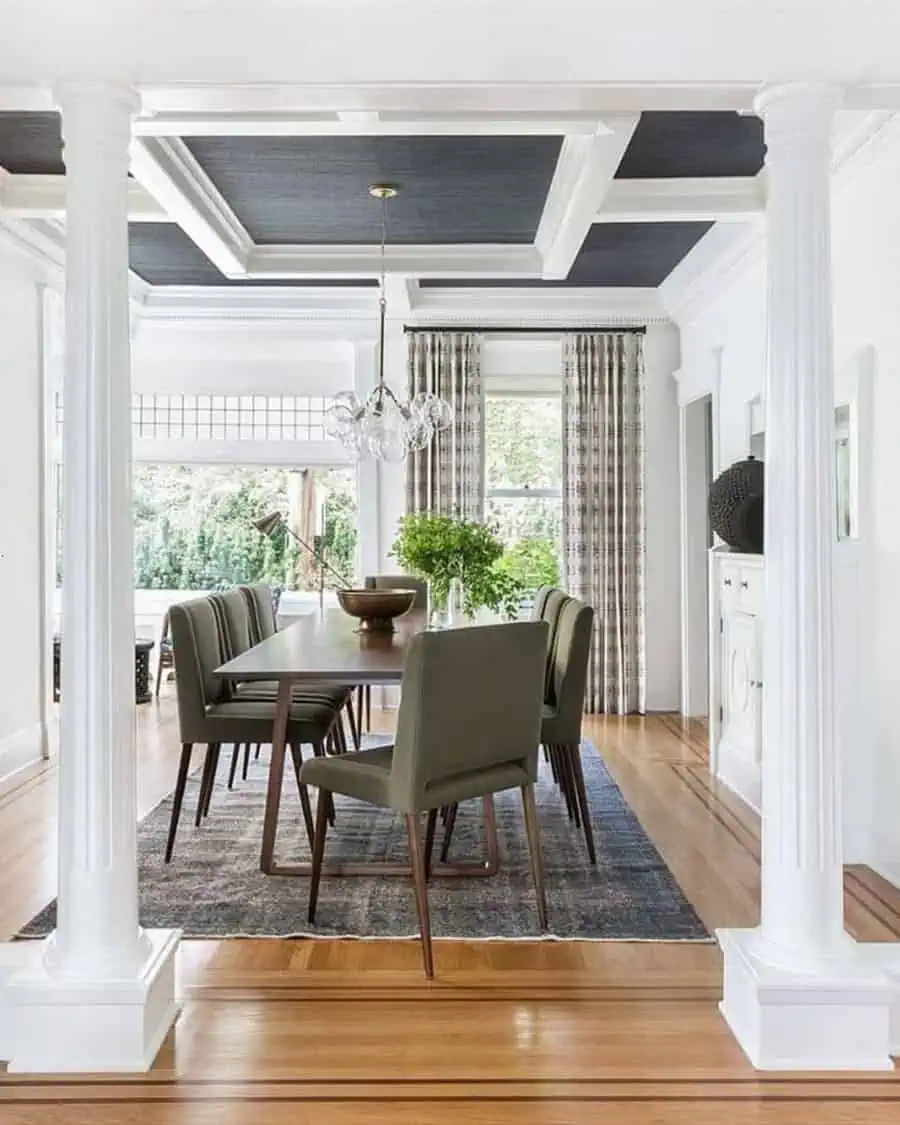 Elegant dining room with a modern coffered ceiling, green upholstered chairs, and a wood table.