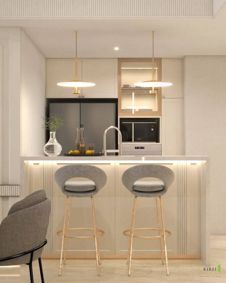 Elegant kitchen with gold accents, soft lighting, and a sleek island with upholstered bar stools.