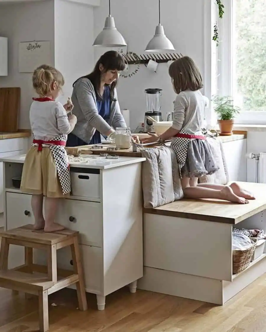 Cozy family-friendly kitchen with a built-in bench, storage, and kids baking with their mother.