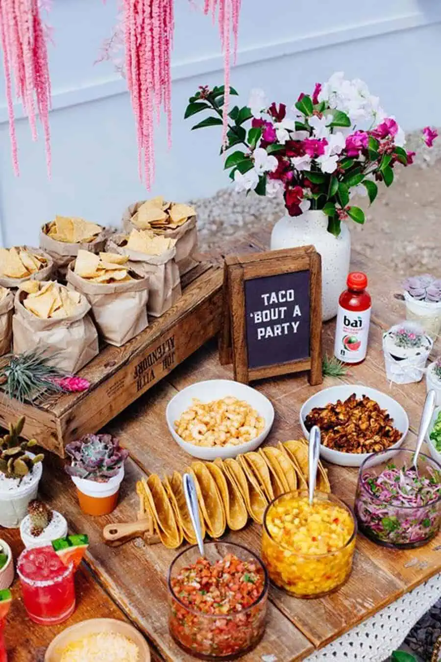 Fiesta-style housewarming party with tacos, salsa, chips, vibrant decor, and festive drinks.