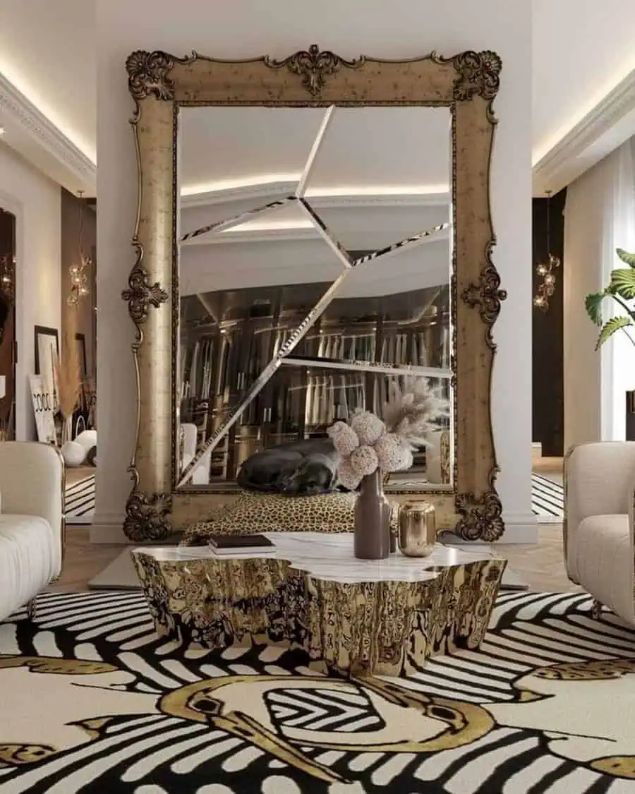 Ornate gold-framed mirror with a fractured design in a luxurious living room.