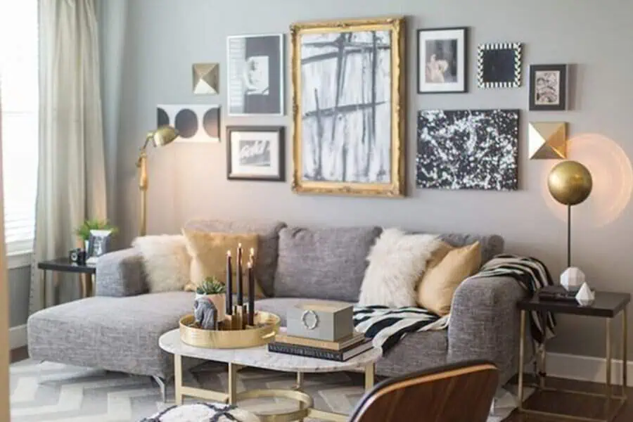 Grey and white living room with gold accents, a gallery wall, and a cozy sectional sofa.