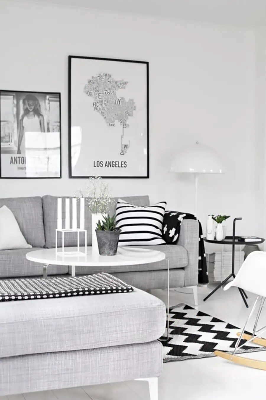 Modern grey and white living room with black accents, geometric patterns, and minimalist decor.