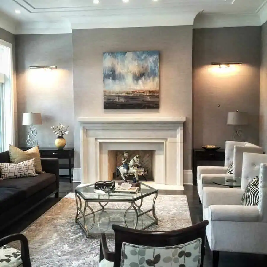 Grey and white living room with a fireplace, elegant seating, and a modern abstract painting.