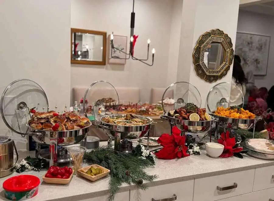 Holiday-themed housewarming party with a festive buffet spread, seasonal decorations, and warm ambiance.