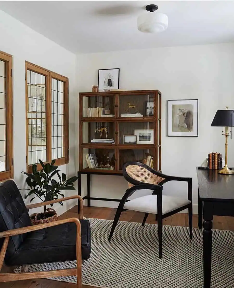 Home office with mixed wood tones, black accents, a vintage bookshelf, and a cozy ambiance.