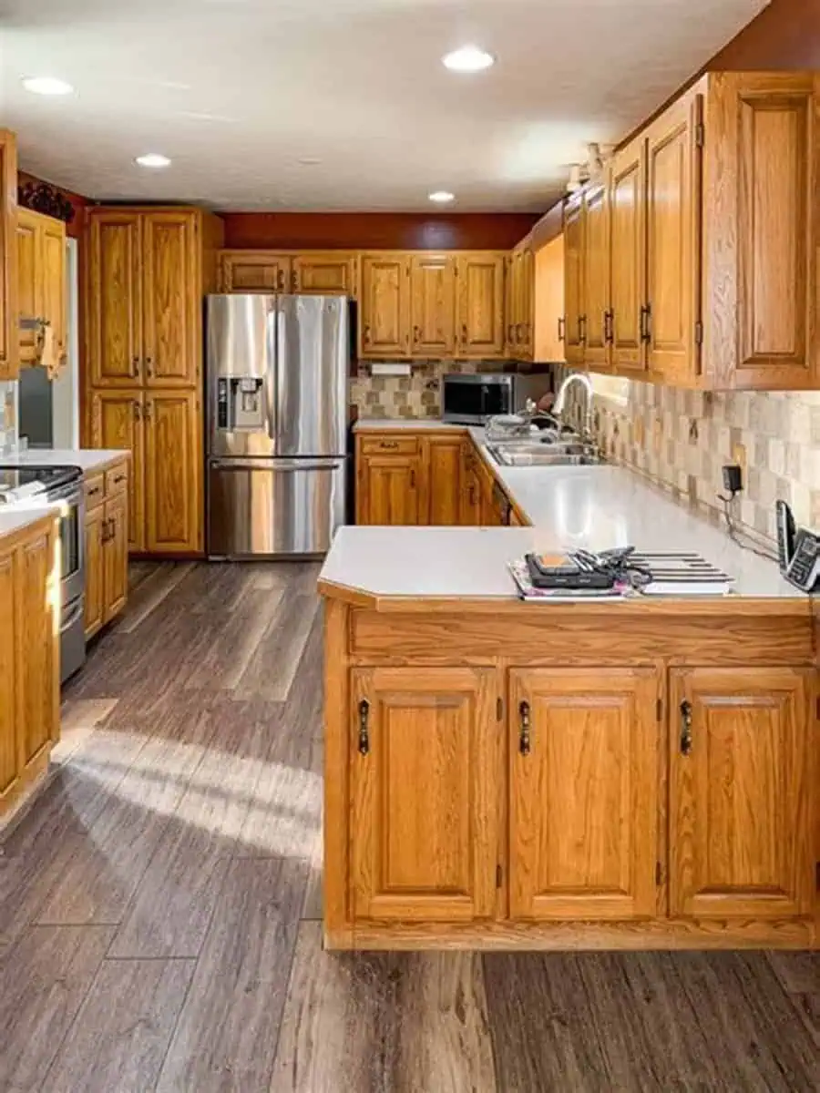 Honey-toned kitchen with cozy interiors, warm oak cabinets, mixed wood tones, and modern accents.