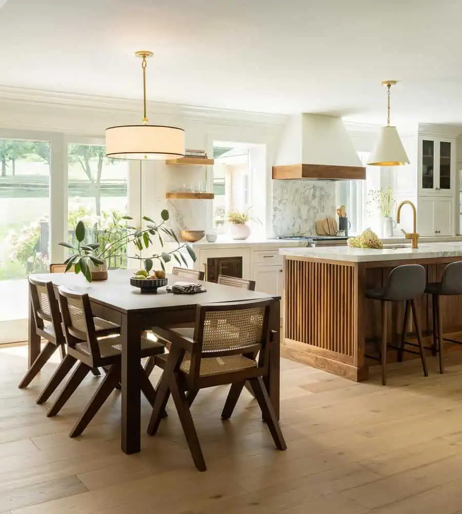 Kitchen and dining space with light flooring, dark tables, and mixed wood tones for a balanced look.