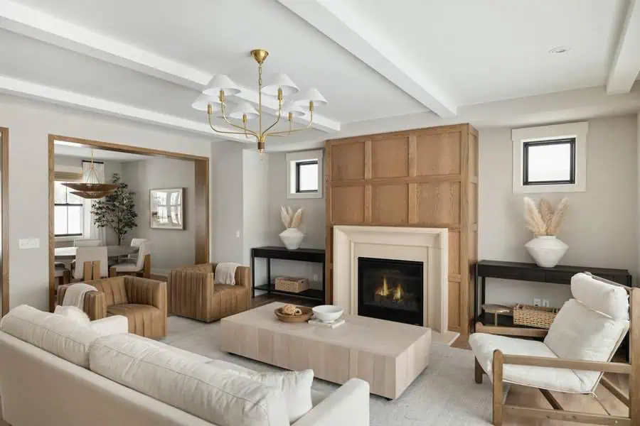 Living room blending painted and natural finishes, featuring mixed wood tones, a warm fireplace, and cozy textures.