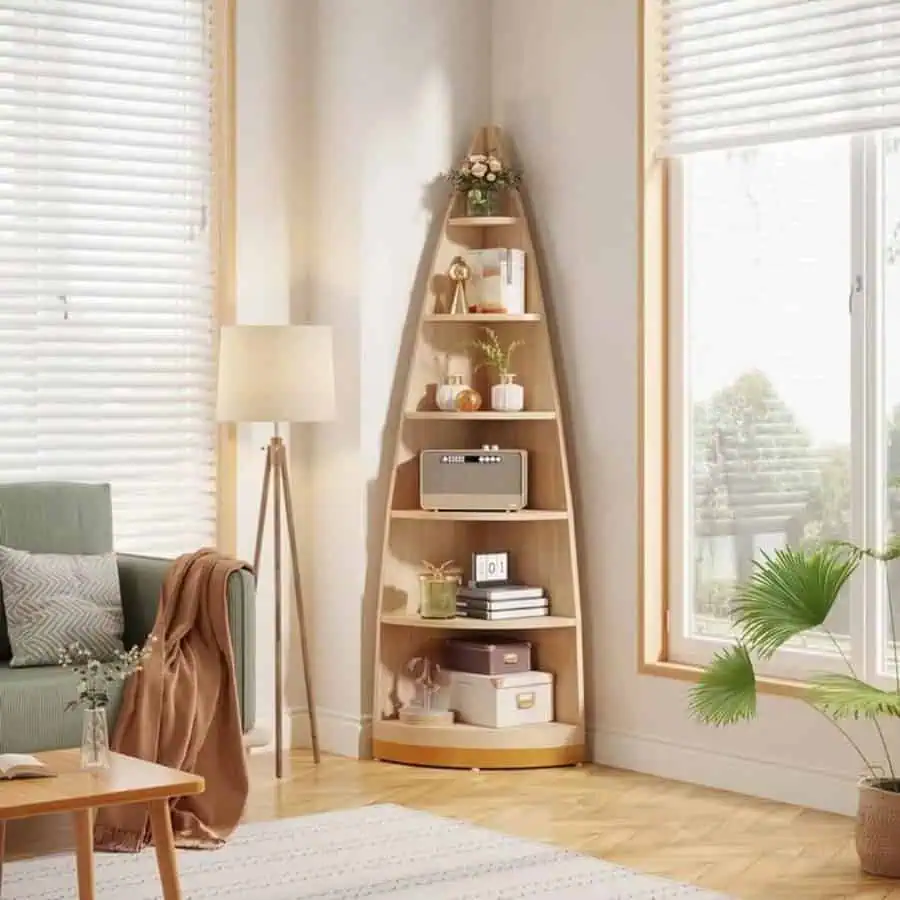 Minimalist living room with a space-saving corner bookshelf, cozy decor, and natural light.