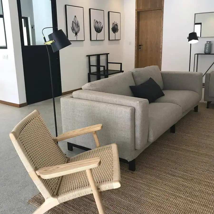 Living room with airy spaces, light furniture, woven textures, and mixed wood tones for warmth.