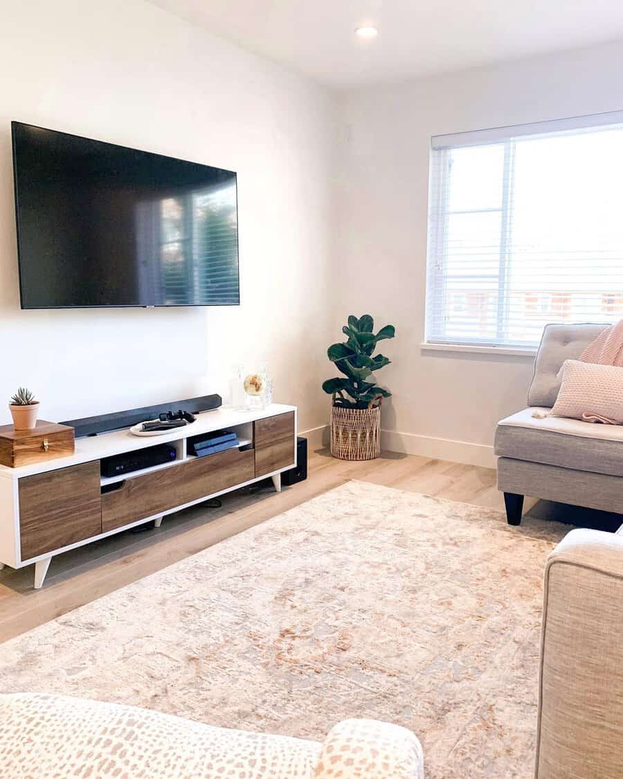 Bright and cozy living room with mixed wood tones, soft neutral decor, and a modern media console.