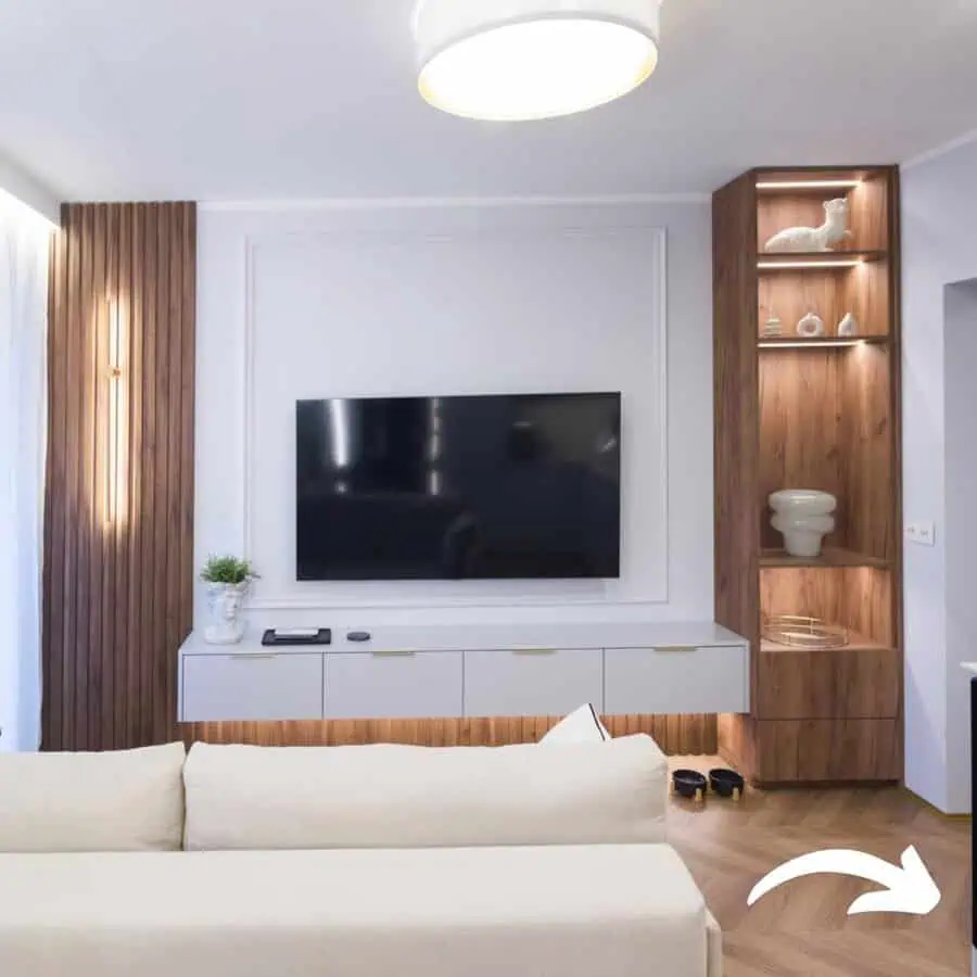 Living room with stylish paneling, mixed wood tones, built-in shelving, and warm ambient lighting.