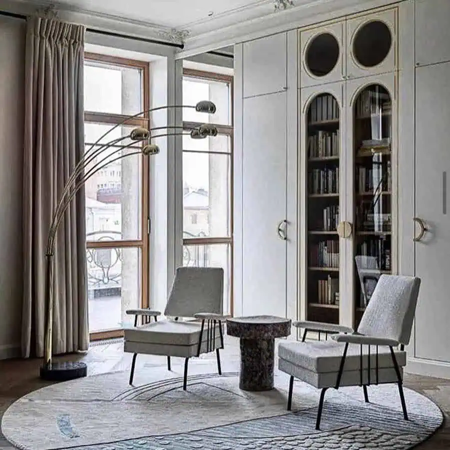 Minimalist aesthetic home library with sleek glass cabinets, modern seating, and soft natural light.